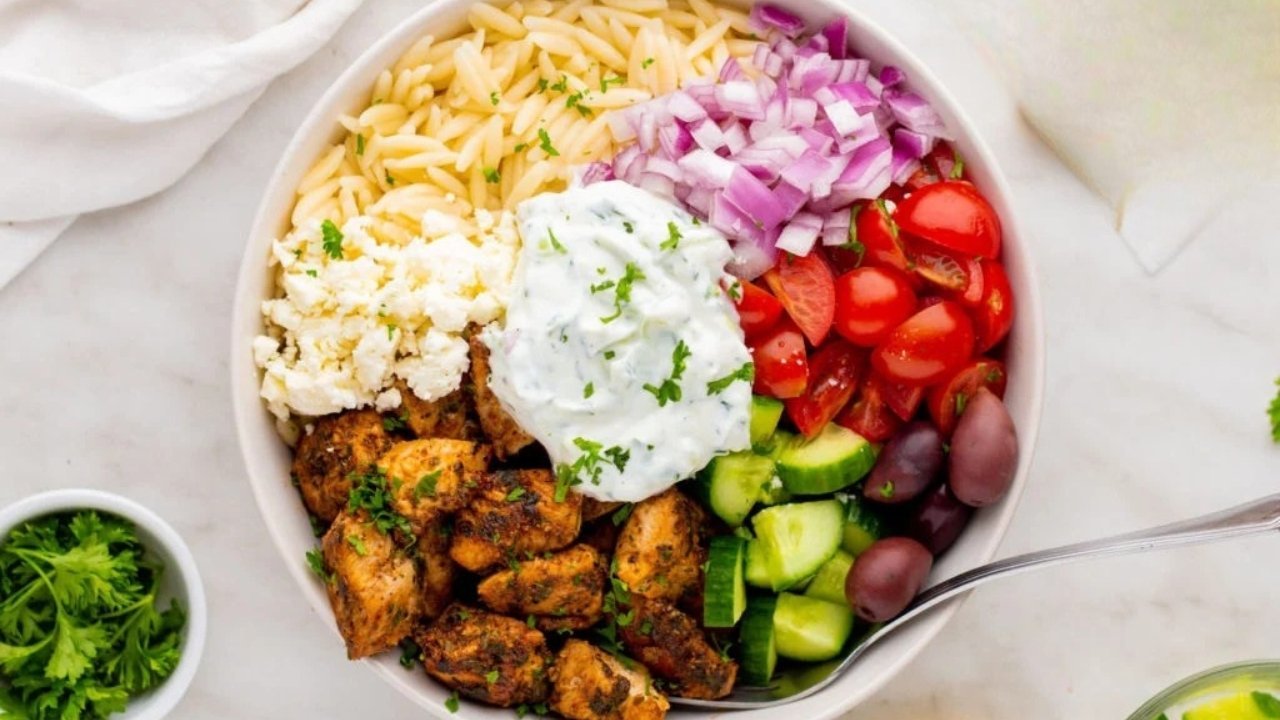 Fresh chicken gyro platter with rice, salad, and sauces served at Mehfil in Baltimore